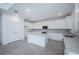 Modern kitchen boasts white cabinets, stainless steel appliances, granite countertops and a large island at 9199 Waverly Walk Dr, Orlando, FL 32817