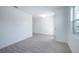 A bright living room with light gray wood-look floors, white walls and baseboards, and a window at 9199 Waverly Walk Dr, Orlando, FL 32817