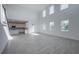 Bright living room features soaring ceilings, many windows and tile floors open to the modern kitchen at 9199 Waverly Walk Dr, Orlando, FL 32817