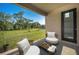 A serene patio featuring comfortable seating and a view of the lush green lawn at 9199 Waverly Walk Dr, Orlando, FL 32817