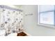 Bright bathroom with a seashell patterned shower curtain and a window with bright light at 9422 Jaywood Rd, Winter Garden, FL 34787