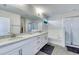 Modern bathroom featuring double sinks, granite countertops, and a walk-in shower at 9422 Jaywood Rd, Winter Garden, FL 34787