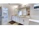 Bright bathroom features double sinks, granite countertops, and ample vanity storage at 9422 Jaywood Rd, Winter Garden, FL 34787
