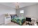 Well-lit bedroom features a cozy bed, a desk and a plush toy for a playful touch at 9422 Jaywood Rd, Winter Garden, FL 34787