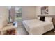 Bright bedroom featuring a bed, desk, and large window offering natural light at 9422 Jaywood Rd, Winter Garden, FL 34787