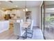 Modern dining area featuring sleek white dining set and contemporary chandelier with access to patio at 9422 Jaywood Rd, Winter Garden, FL 34787