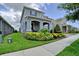 Beautifully landscaped front yard leading to a two-story home with a covered porch and double garage at 9422 Jaywood Rd, Winter Garden, FL 34787