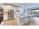 Kitchen showing a large island with seating, stainless steel appliances, and white cabinets at 9422 Jaywood Rd, Winter Garden, FL 34787