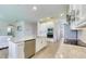 Kitchen showing a large island with barstool seating and stainless steel appliances and white cabinets at 9422 Jaywood Rd, Winter Garden, FL 34787