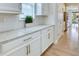 Hallway kitchen featuring white cabinets, modern hardware, granite countertops, and a subway tile backsplash at 9422 Jaywood Rd, Winter Garden, FL 34787