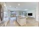 Open-concept kitchen with white cabinets, stainless steel appliances, and an island with seating at 9422 Jaywood Rd, Winter Garden, FL 34787