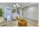 Living room boasting light tile floors, neutral colors, and an arched entryway to dining area at 9422 Jaywood Rd, Winter Garden, FL 34787