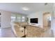Bright living room featuring modern furniture, including a leather sofa set and a shag rug at 9422 Jaywood Rd, Winter Garden, FL 34787