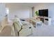 Bright living room with cozy recliner, large television, and open doorway at 9422 Jaywood Rd, Winter Garden, FL 34787