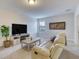 Cozy living room with comfortable seating, TV, and a view through the window at 9422 Jaywood Rd, Winter Garden, FL 34787