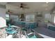 Covered outdoor kitchen and dining area with grills, bar, and seating with lake views at 9422 Jaywood Rd, Winter Garden, FL 34787