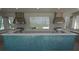 Outdoor kitchen with mosaic tile, two grills, stainless steel vents, and white countertops at 9422 Jaywood Rd, Winter Garden, FL 34787