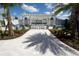 Outdoor lounge and seating area with white pergola, pavers, plants, and palm trees at 9422 Jaywood Rd, Winter Garden, FL 34787