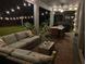 Covered patio features a comfortable lounge area, dining area, and string lights, perfect for outdoor entertaining at 9422 Jaywood Rd, Winter Garden, FL 34787