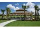 Community pavilion with picnic tables surrounded by palm trees and lush green lawn at 9422 Jaywood Rd, Winter Garden, FL 34787