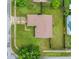 Aerial view of a well-maintained home featuring a spacious backyard with green grass at 9833 Tattersall Ave, Orlando, FL 32817