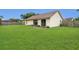 Well-maintained back yard with sliding glass doors opening to the home's interior at 9833 Tattersall Ave, Orlando, FL 32817