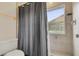 This bathroom features a shower and tub, a toilet, and tan tile at 9833 Tattersall Ave, Orlando, FL 32817