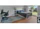 This bedroom features a desk, bed, shelves, laminate flooring, and natural light at 9833 Tattersall Ave, Orlando, FL 32817