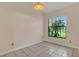 This bedroom has a large window, tile floor, and a ceiling light at 9833 Tattersall Ave, Orlando, FL 32817