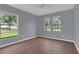 This bedroom features two beautiful windows and modern laminate flooring throughout the space at 9833 Tattersall Ave, Orlando, FL 32817