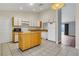 Kitchen with granite counters, stainless steel appliances, island and access to living room at 9833 Tattersall Ave, Orlando, FL 32817