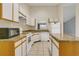 Bright kitchen features granite countertops, white cabinets, stainless steel appliances and kitchen island at 9833 Tattersall Ave, Orlando, FL 32817