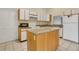 Bright kitchen features granite countertops, white cabinets, stainless steel appliances and kitchen island at 9833 Tattersall Ave, Orlando, FL 32817
