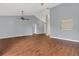Spacious living room featuring hardwood flooring, ceiling fans and a large open space at 9833 Tattersall Ave, Orlando, FL 32817