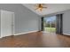 Open living room with neutral walls, hardwood floors and a sliding door to the backyard at 9833 Tattersall Ave, Orlando, FL 32817