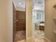 Bathroom featuring travertine flooring, walk-in shower and separate tub at 10170 Se 106Th Ln, Belleview, FL 34420