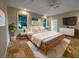 Serene bedroom featuring a king-sized bed, plush carpet, modern decor, and ample natural light at 10170 Se 106Th Ln, Belleview, FL 34420