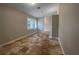 Bedroom featuring travertine floors, a large window with plantation shutters, and neutral paint at 10170 Se 106Th Ln, Belleview, FL 34420