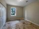 Bedroom with travertine tile flooring and a view of the outside from a window at 10170 Se 106Th Ln, Belleview, FL 34420