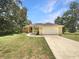 Charming single-story home featuring a spacious front yard, attached two-car garage and inviting curb appeal at 10170 Se 106Th Ln, Belleview, FL 34420