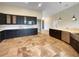 Modern kitchen featuring dark cabinetry, stainless steel appliances, ample countertop space, and tiled floors at 10170 Se 106Th Ln, Belleview, FL 34420