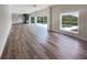 Spacious living room with wood floors, spiral staircase, and a pool view through large windows at 10170 Se 106Th Ln, Belleview, FL 34420