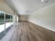 Expansive living room with wood floors and sliding glass doors leading to the outdoor pool at 10170 Se 106Th Ln, Belleview, FL 34420
