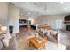 Bright living room features sleek tile flooring, stylish furniture, and a modern kitchen with dark cabinets at 10170 Se 106Th Ln, Belleview, FL 34420