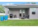 Inviting back porch with BBQ grill and chairs overlooking well maintained lawn with privacy fence at 1020 Taproot Dr, Winter Springs, FL 32708