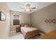 Neutral bedroom features wood-look flooring, a ceiling fan, and a twin bed with a patterned bedspread at 1020 Taproot Dr, Winter Springs, FL 32708