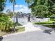 Gray single-Gathering home on a spacious lot, featuring a two-car garage and fenced yard at 1020 Taproot Dr, Winter Springs, FL 32708