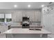 Stylish kitchen features gray cabinetry, stainless appliances, and ample counter space for cooking at 1020 Taproot Dr, Winter Springs, FL 32708