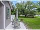 Relaxing outdoor patio with rocking chairs and table, perfect for enjoying the serene backyard at 1020 Taproot Dr, Winter Springs, FL 32708