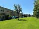 Expansive backyard view showcasing lush green grass behind townhomes with lots of space for outdoor enjoyment at 11187 Savannah Landing Cir, Orlando, FL 32832